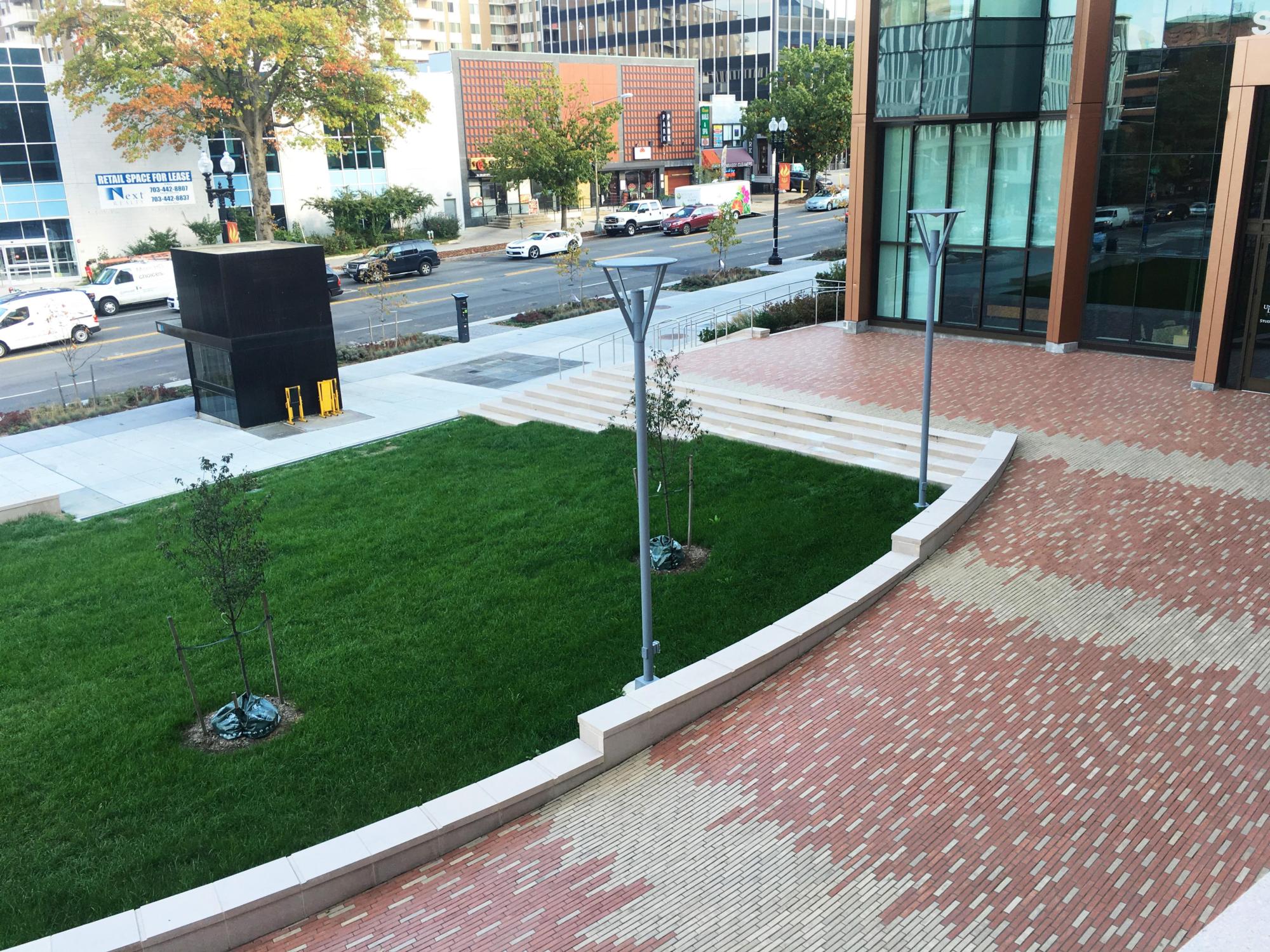Image of the brick paving and manicured, green lawn at the University of the District of Columbia Student Center