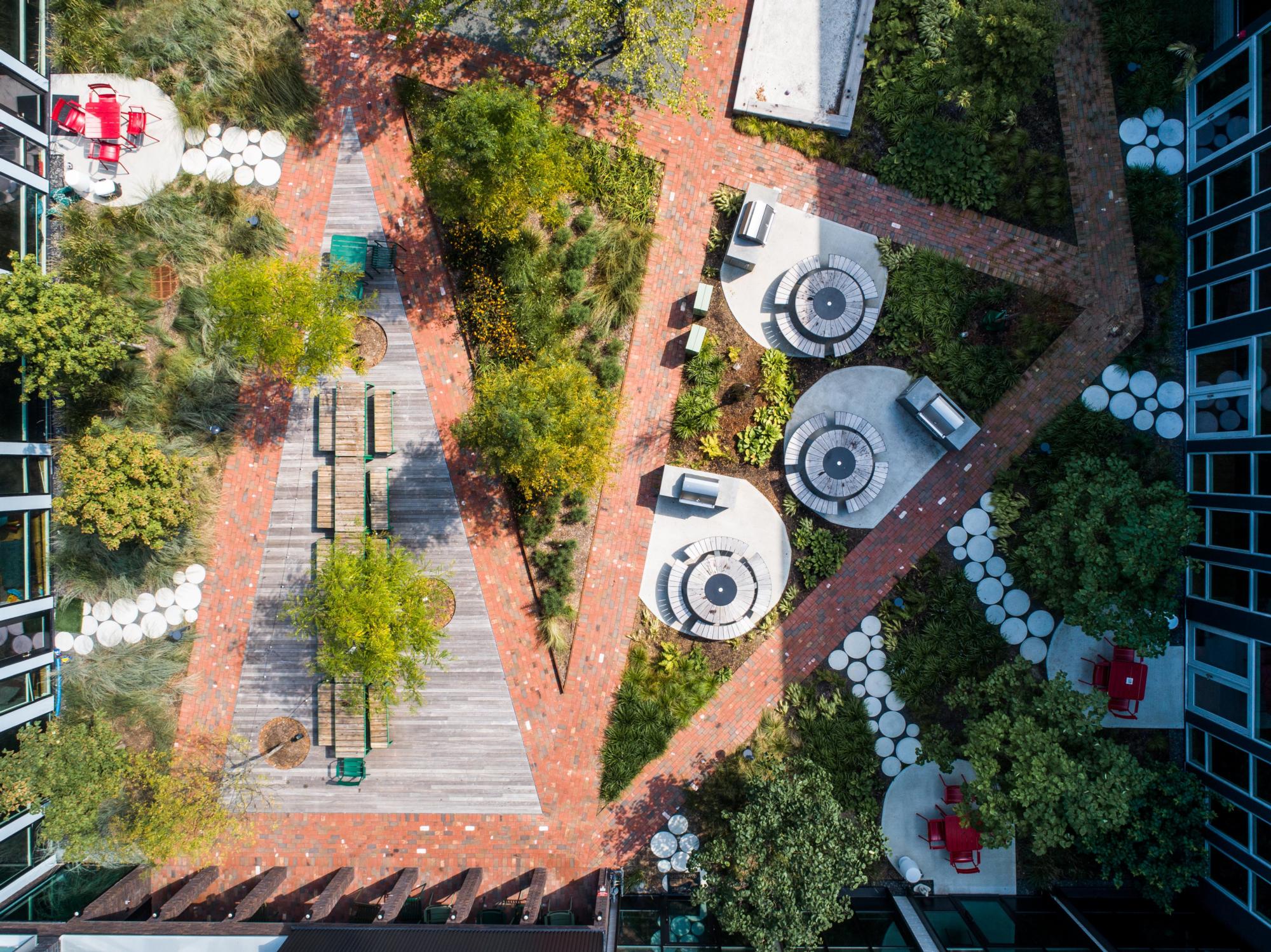 Overhead image of the brick walkway, plants, and outdoor tables and chairs at the Urby Harrison