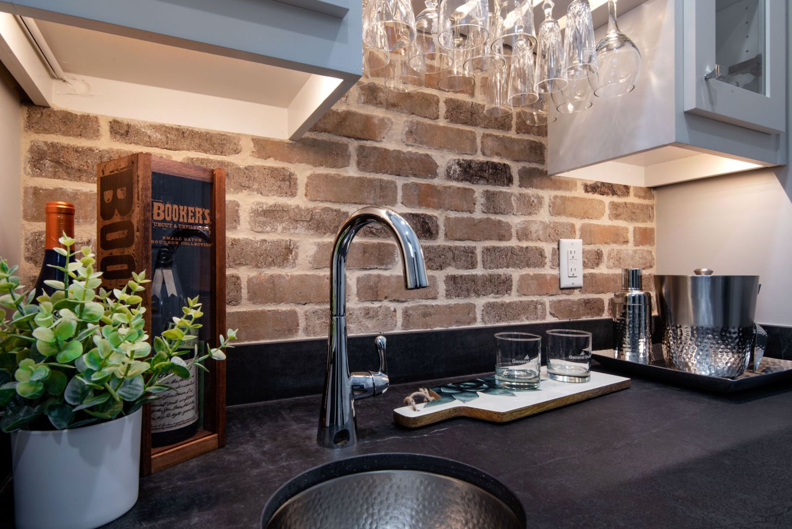 Kitchen sink with brick accent wall