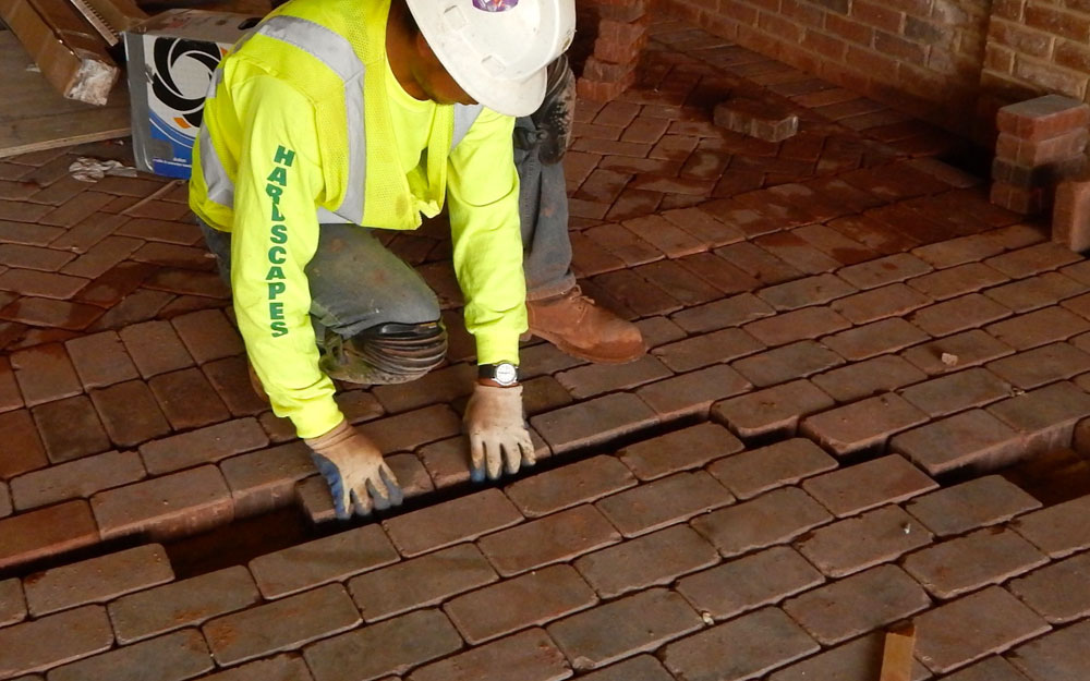A worker installing brick