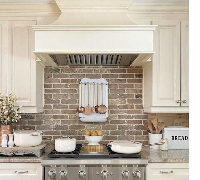 Brick backsplash behind a stove