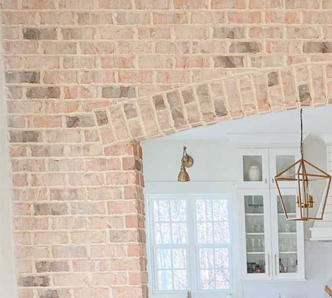 Thin brick archway entering kitchen