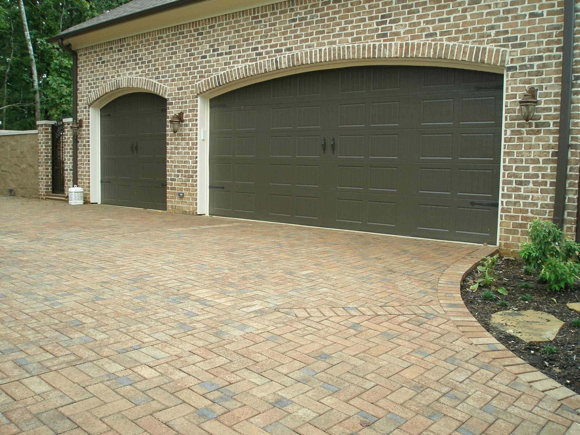 Image of a brick driveway and garage