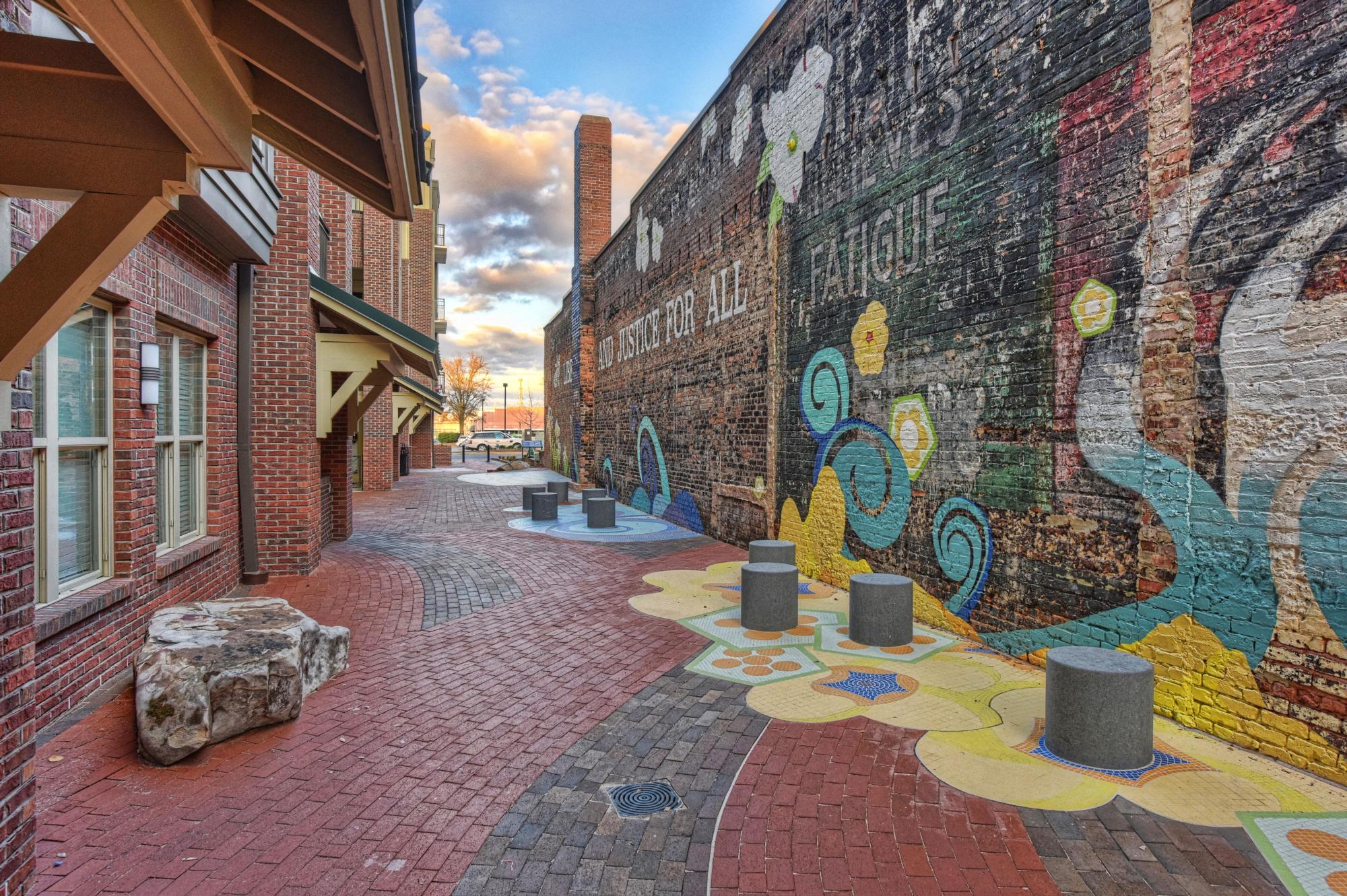 Image of a bricked alleyway with floral designs and brick buildings