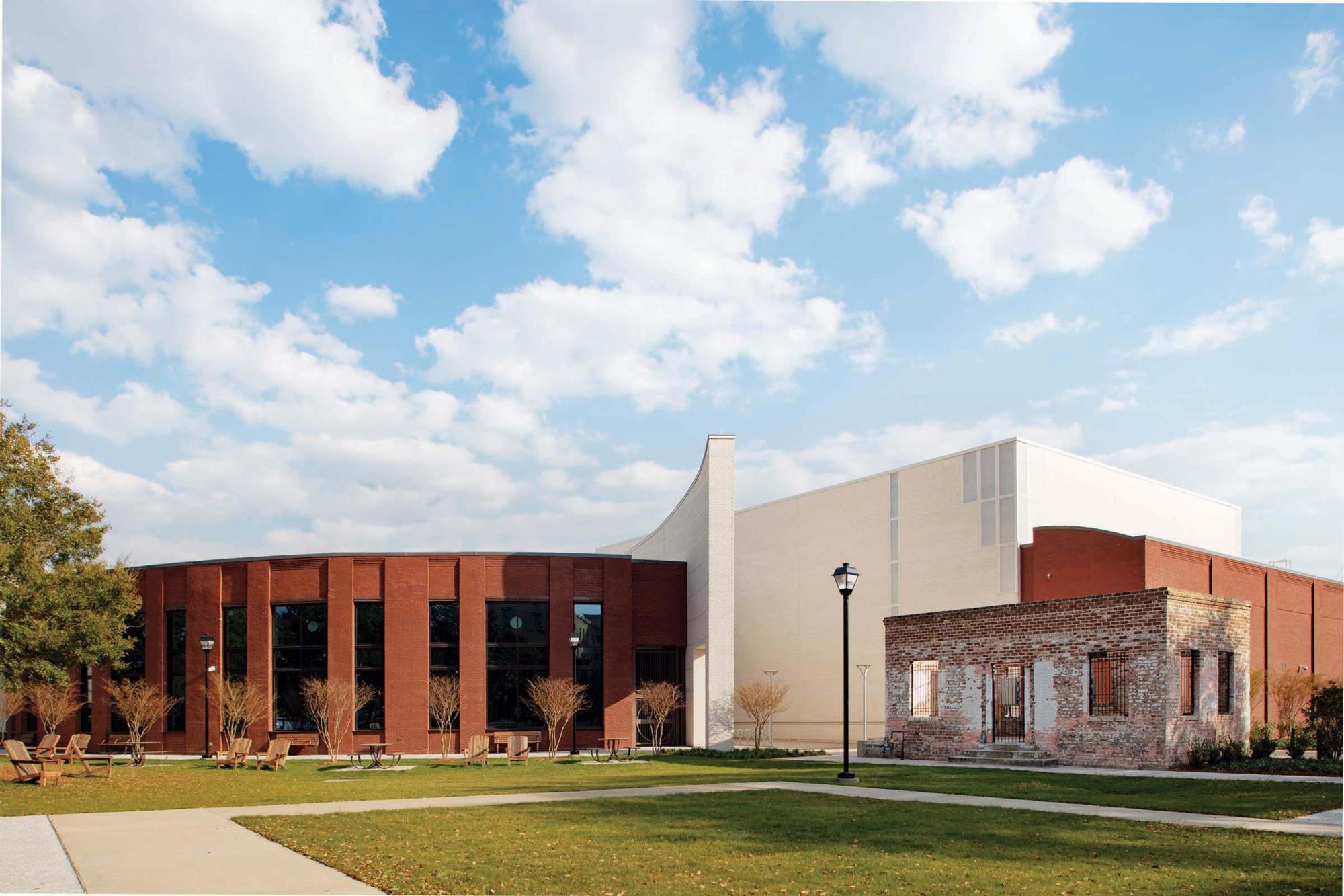 Image of the bricked exterior of the Savannah Cultural Arts Center with a blue sky above it