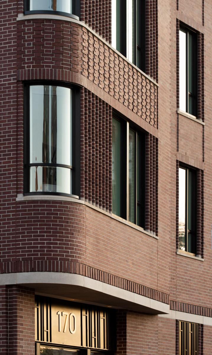 Image of the brown bricked exterior of The Whitney Hotel