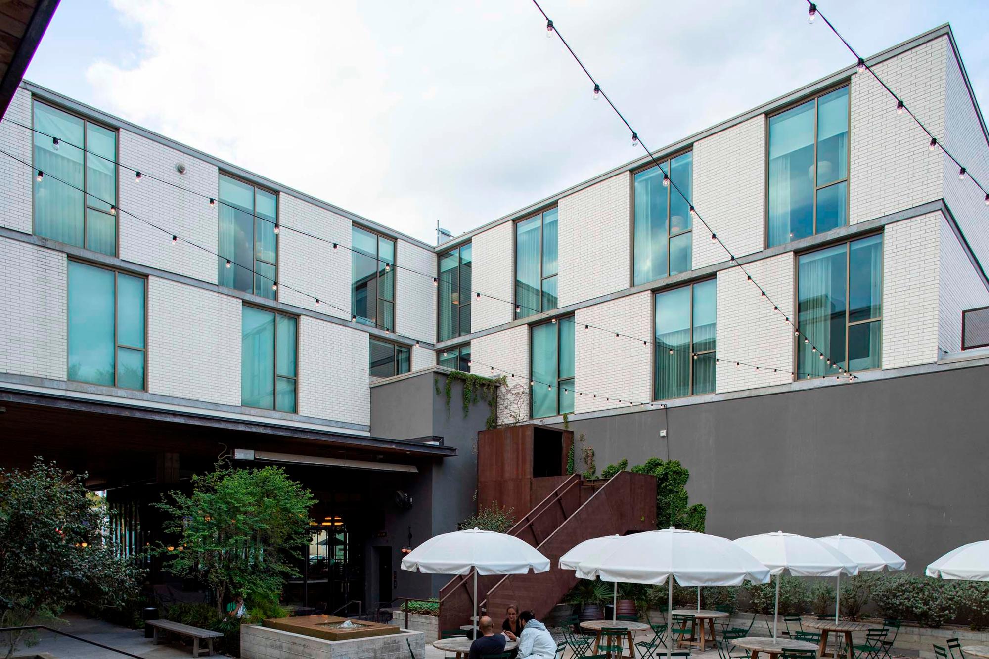 Image of the patio and bricked, windowed walls at the South Congress Hotel