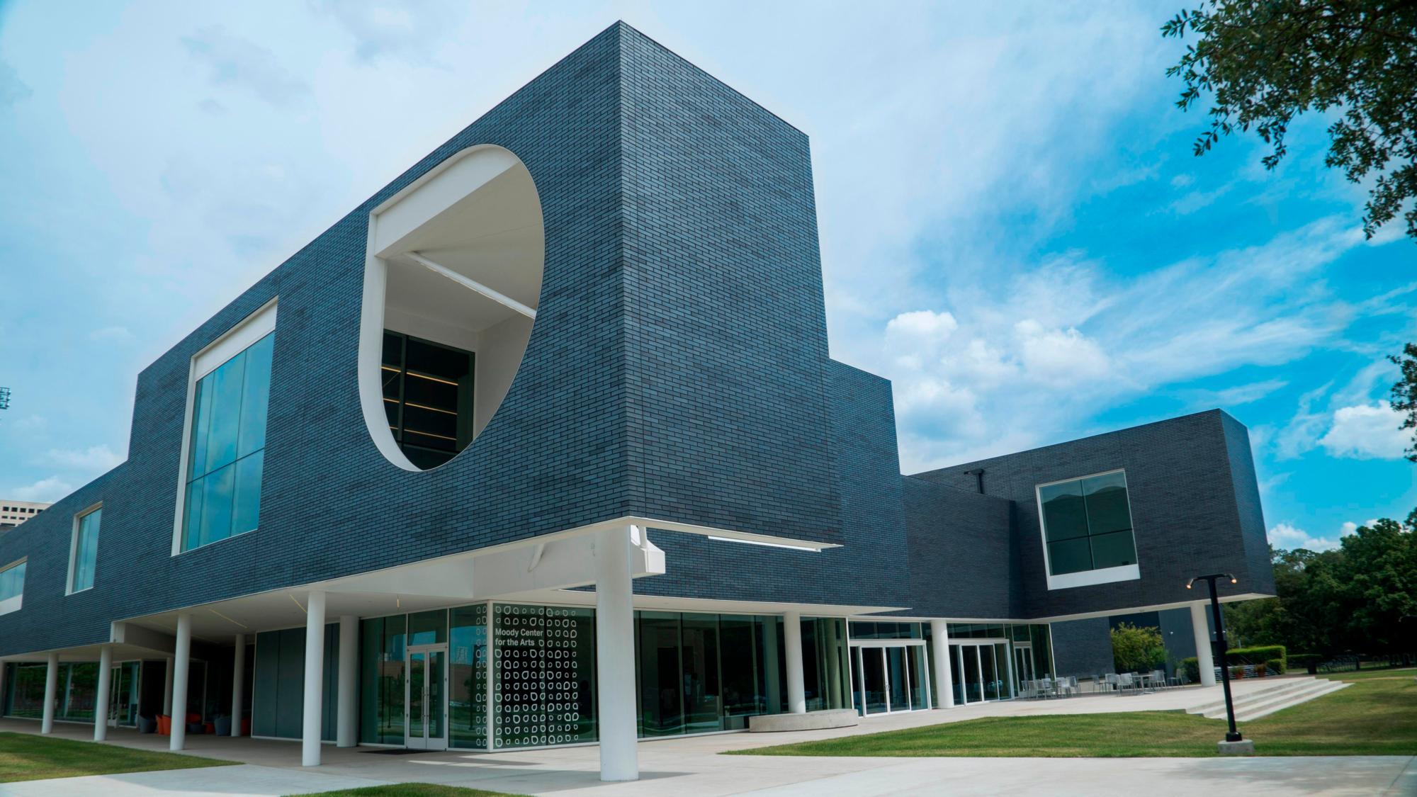 Image of the exterior of the darkly bricked and white columned Moody Center for the Arts - Rice University