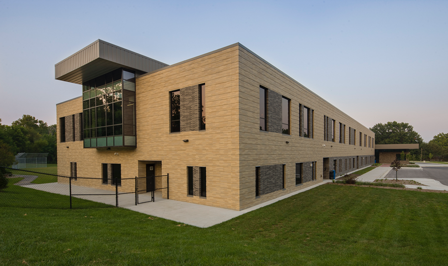 Image of the brown brick and vibrantly emerald lawns of Briarwood Elementary School