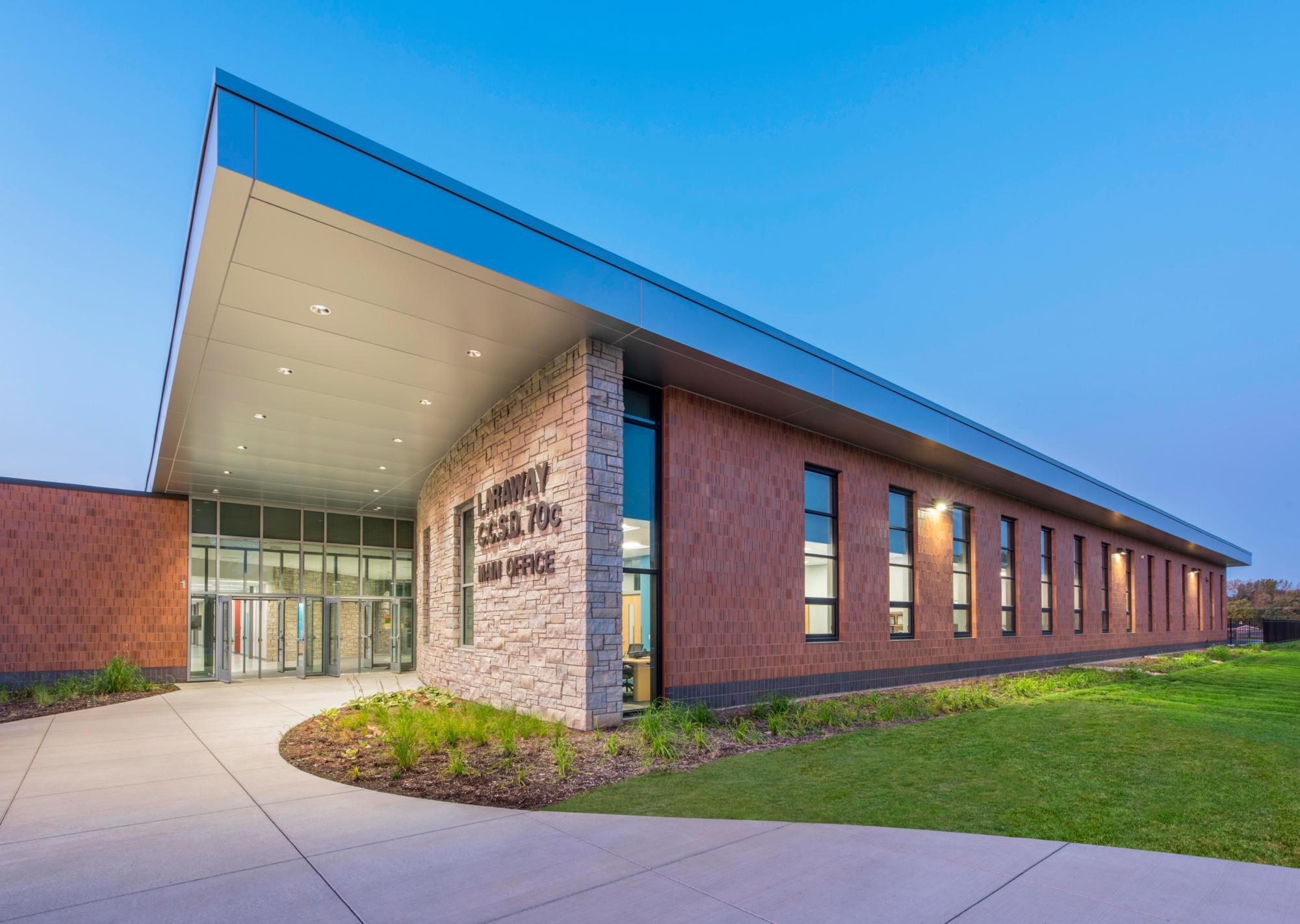 Image of the paved entryway into the red bricked New Laraway Elementary School