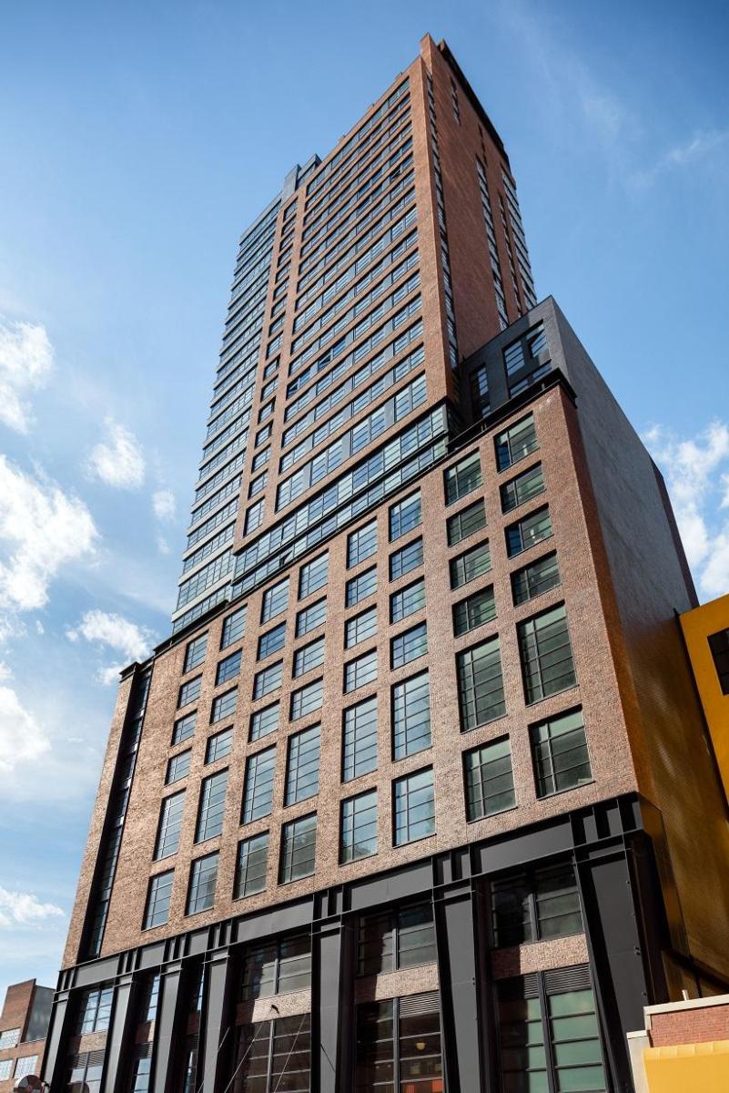 Image of the brown bricked, windowed Henry Hall building