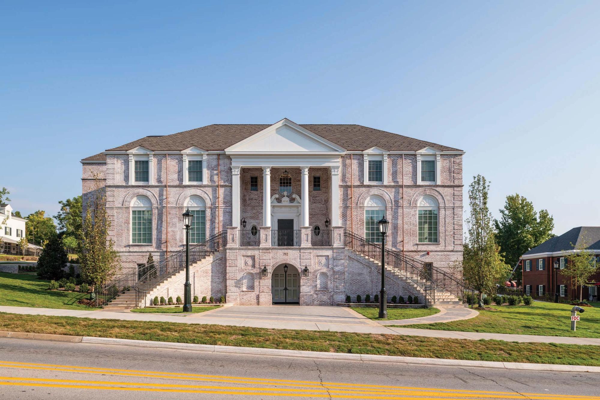 Image of the front of the light colored bricks of the front of the Phi Mu Fraternity building