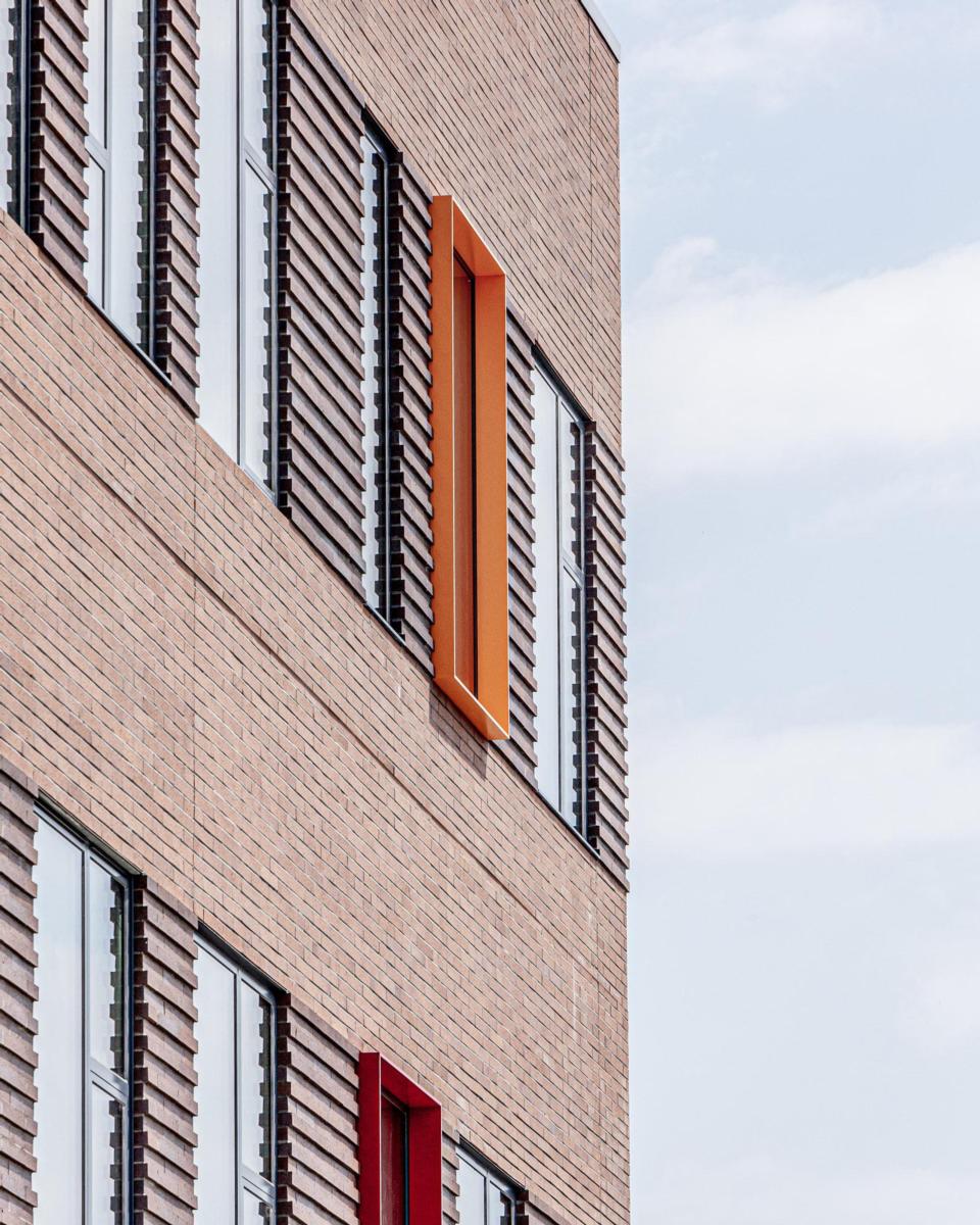 Exterior image of Taft Freshman Academy featuring the red bricked building and cloudy skies