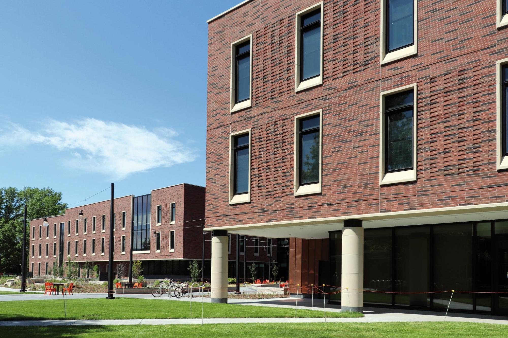Exterior image of the red and brown bricked wall of Grinnell College Humanities and Social Studies Center