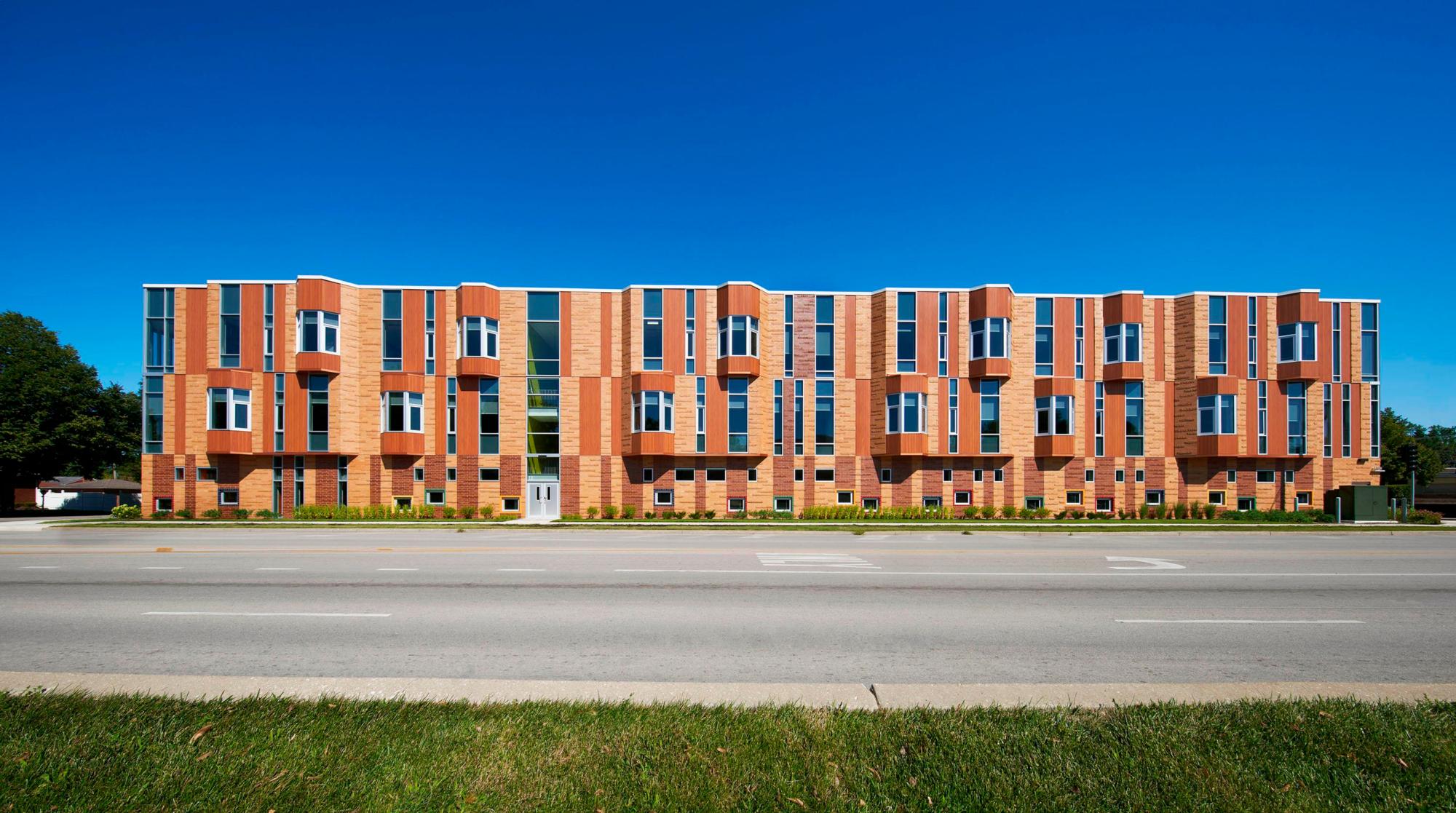 Exterior photograph of the red and yellow bricked K-8 Replacement School