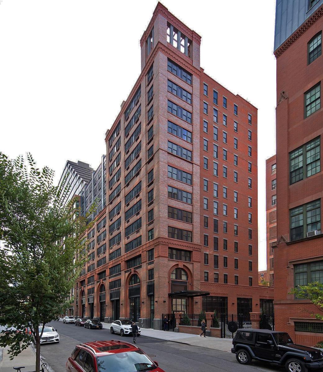 The red bricked exterior of the windowed and tall 540 West 53rd Street building