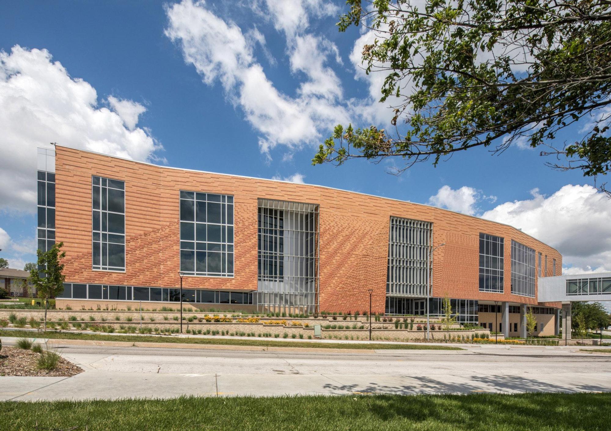 Exterior of the Farm Credit Services of America - West Building building, crafted from red brick an framed by a blue sky