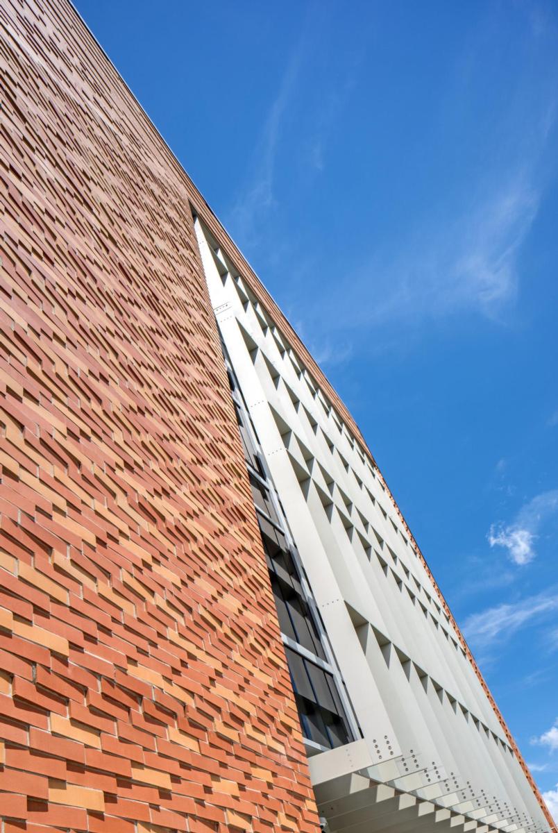 Exterior of the Farm Credit Services of America - West Building building, crafted from red brick an framed by a blue sky