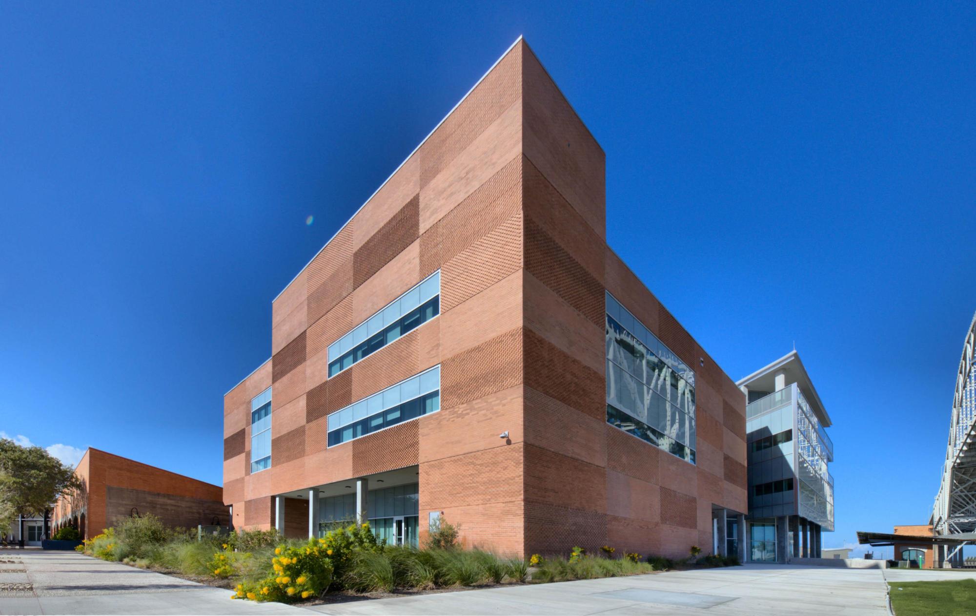 The textured brown brick exterior of the Port of Corpus Christi Administration Building