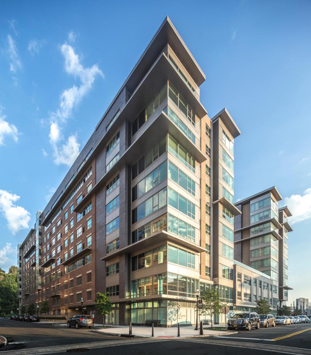 A photo of the RiverParc residential multi-home complex with the sky in the background