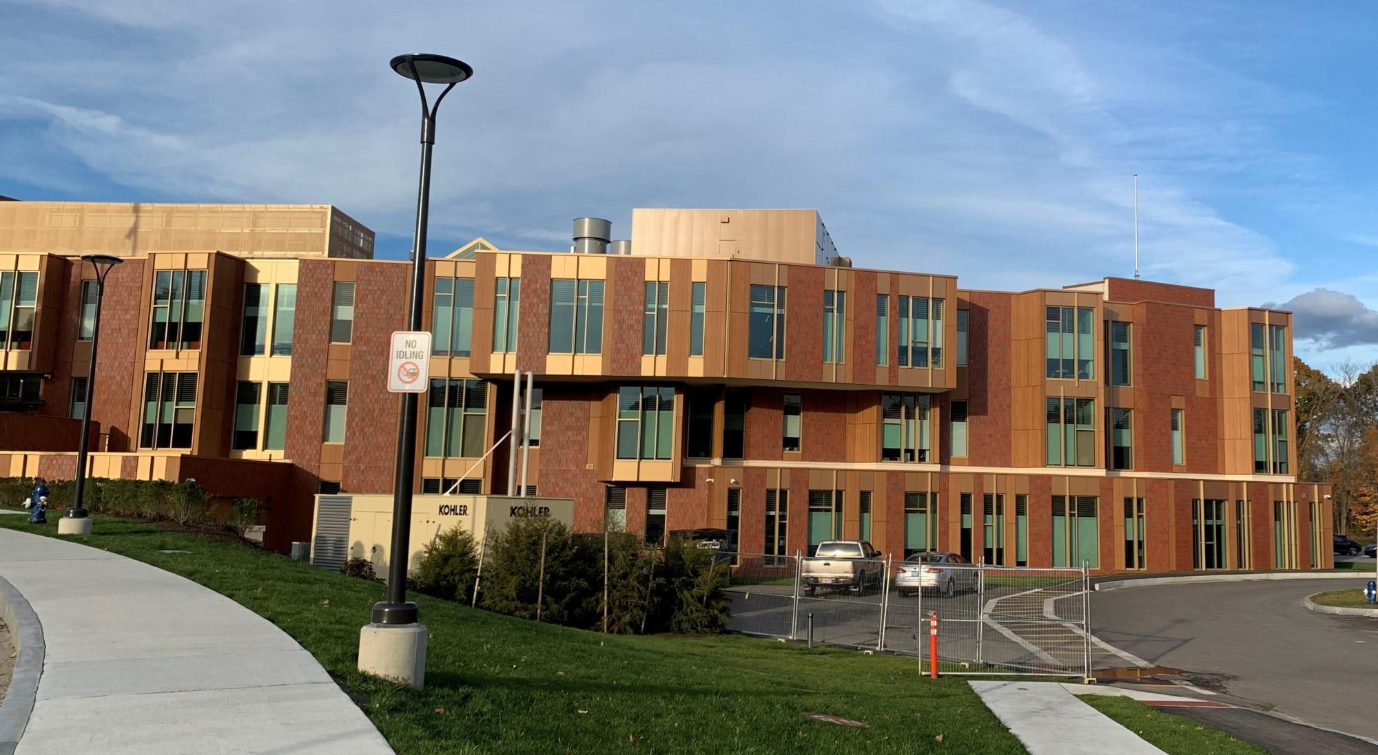 An exterior wall of red brick and the windows of Fuller Middle School