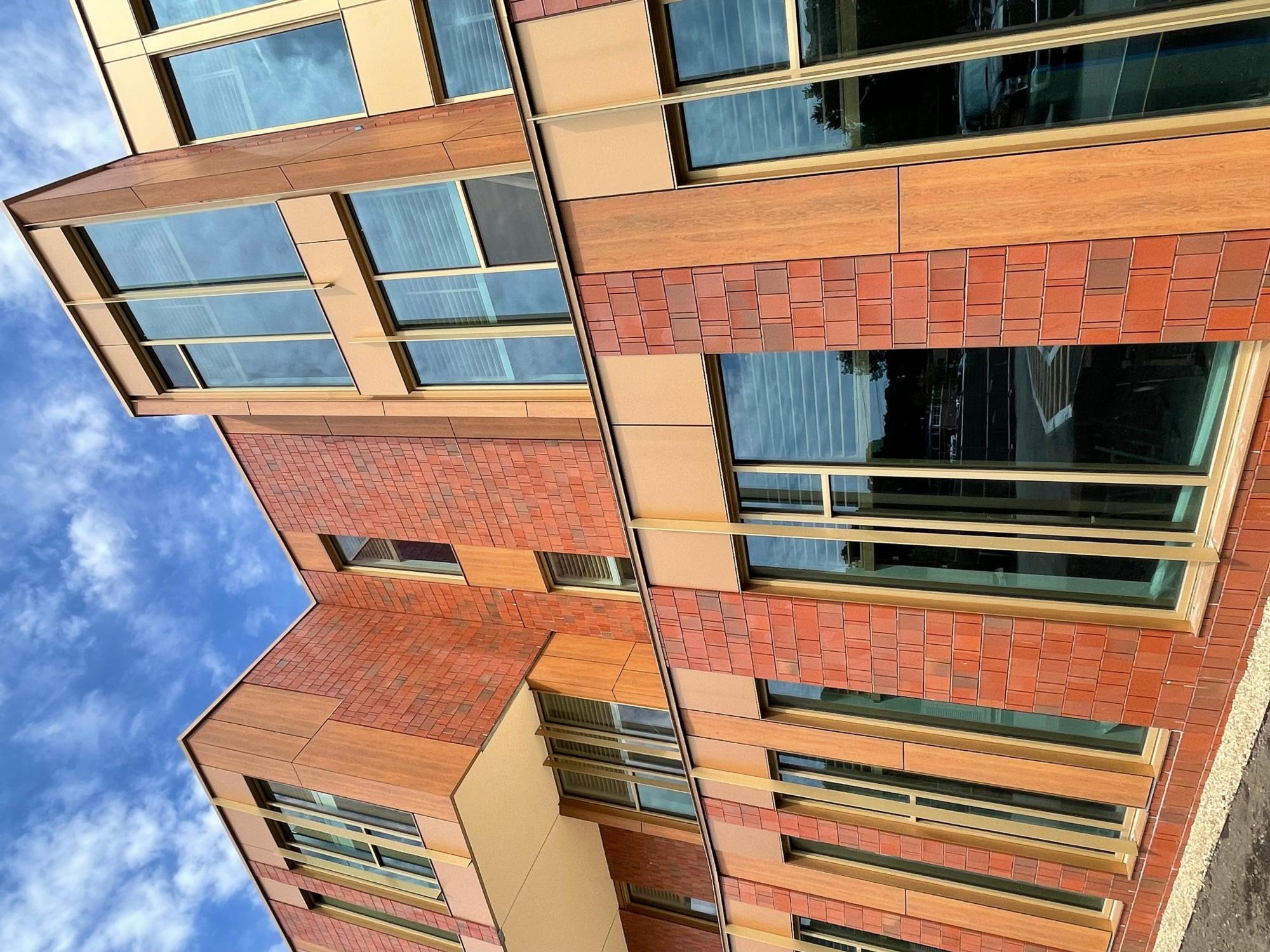 An exterior wall of red brick and the windows of Fuller Middle School