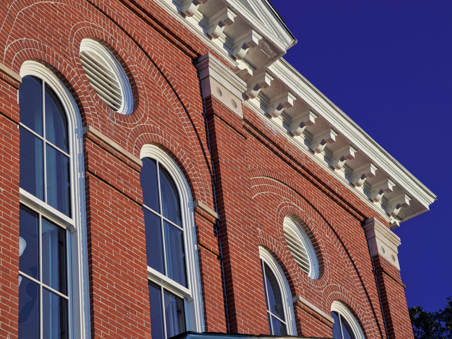 Brick lines the outer walls of Henry County Judicial Center, while decoratively shaped concrete transitions to the roof