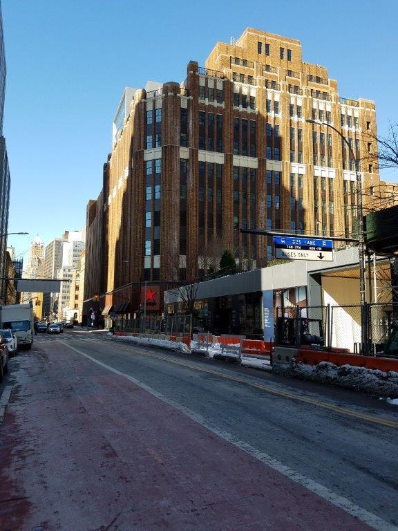 A red bricked Macy's building inside a city block