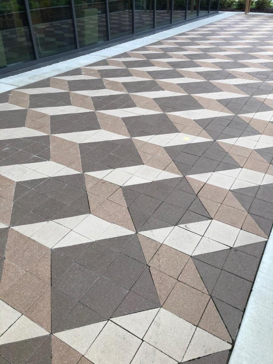 The beige and brown brick walkways of Toledo Mott Library