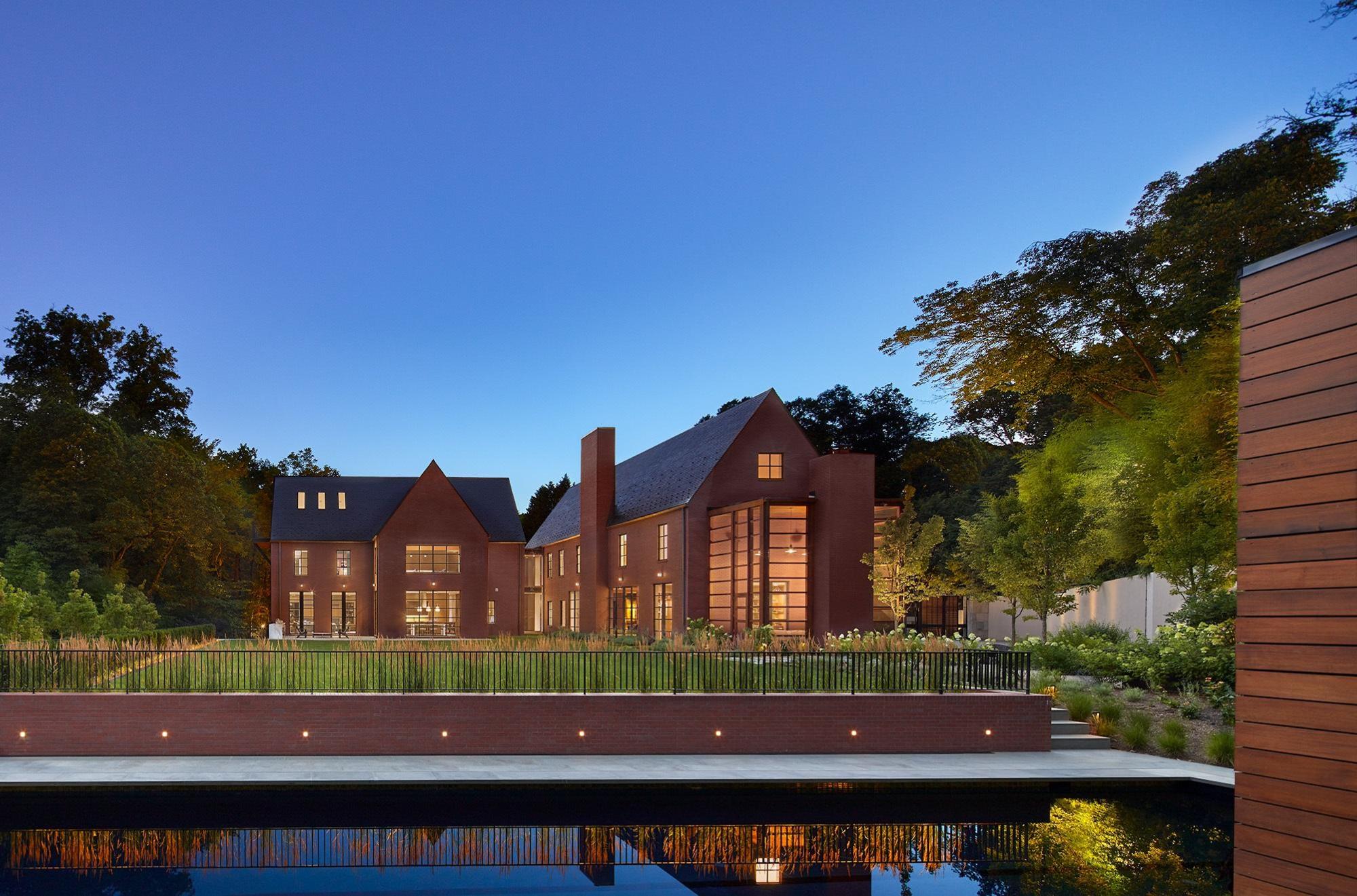 Spacious and luxurious, the Mass Ave Heights family home is ringed with red brick fence and encased in walls of the same