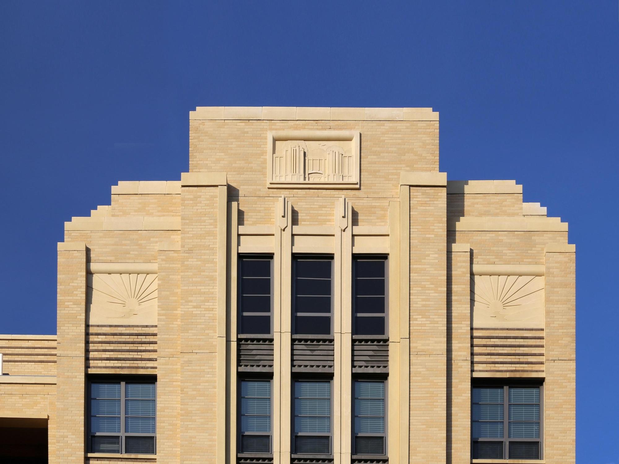 A photo of the beige bricked Park Van Ness building focused on the middle to top of the building