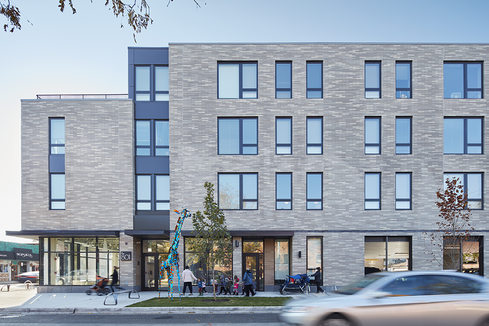 The multi-family housing complex at 801 Oak Park is adorned with bricks of varying light shades