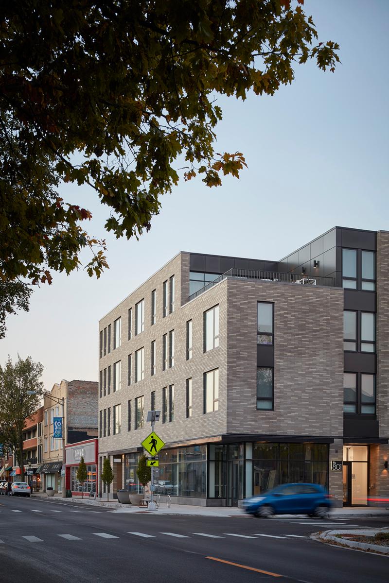 The multi-family housing complex at 801 Oak Park is adorned with bricks of varying light shades