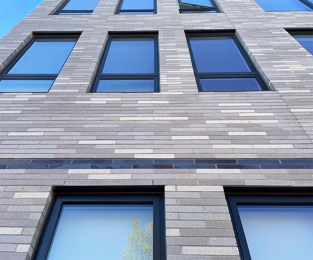 The multi-family housing complex at 801 Oak Park is adorned with bricks of varying light shades