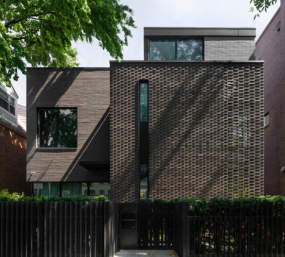 The private residence known as The Brickyard features textured, dark hued bricks