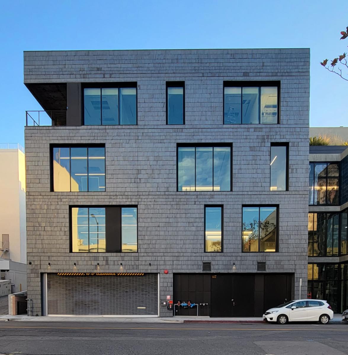 The gray brick exterior of The Brick & The Machine