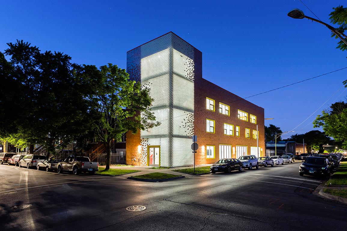 The windowed and bricked exterior of The Enlace