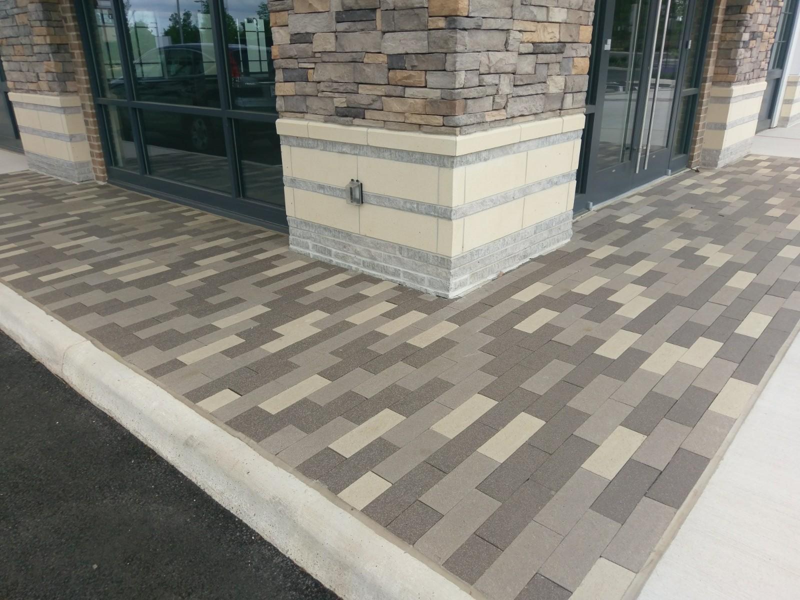 Brick walkway that features many hues of gray in the patterning