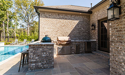 a bricked patio and pool