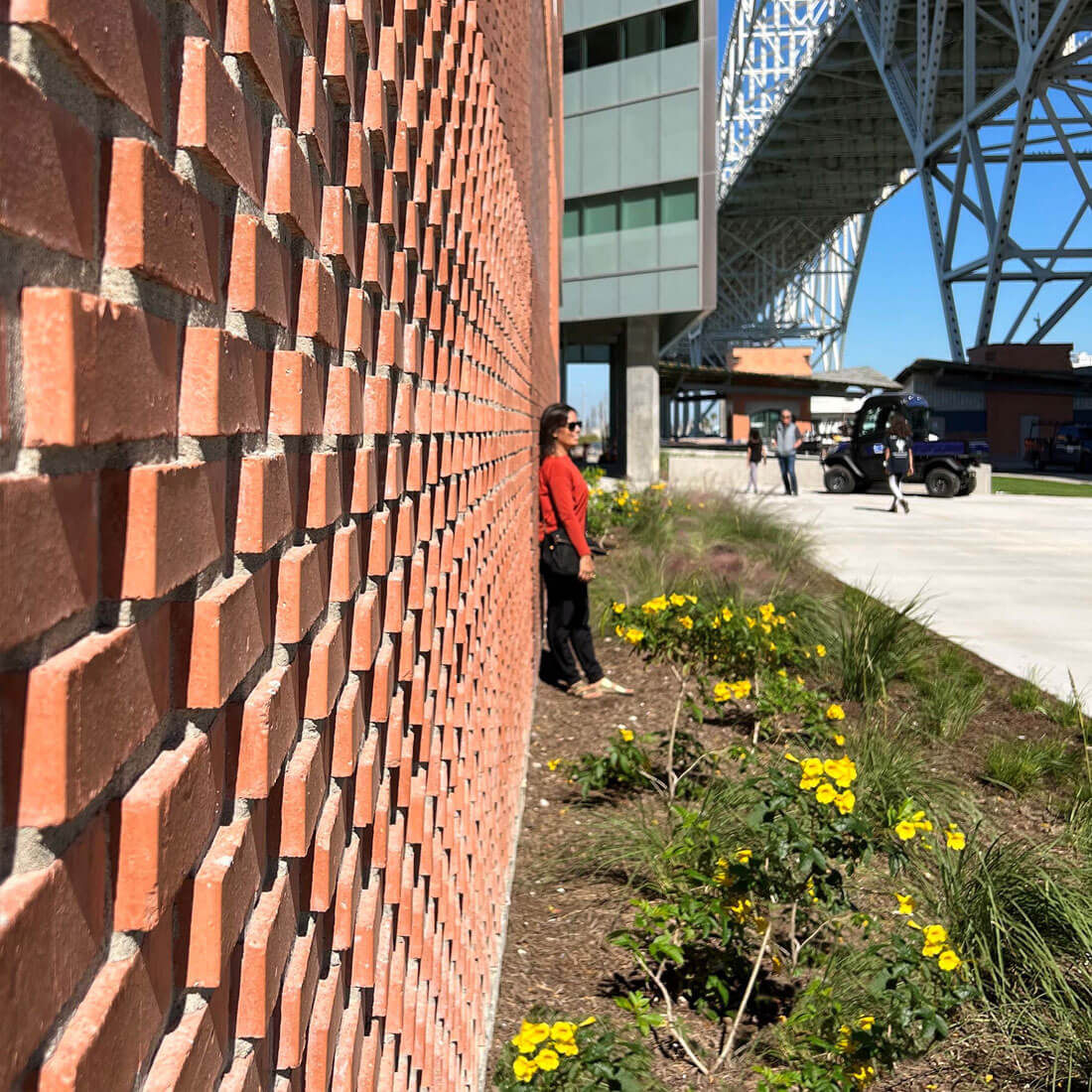 Woman leaning on brick wall for photograph